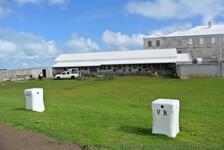 Grassy field and work warehouse next at Bermuda National Museum grounds near Commissioner's House.jpg