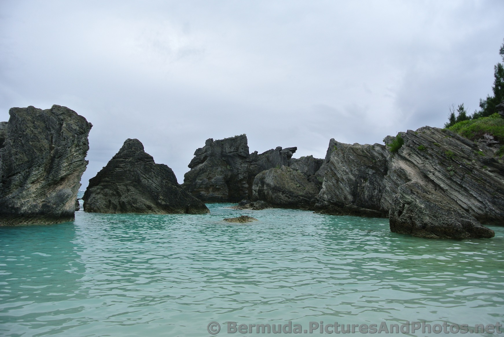 Rocky formations surround the Horseshoe Bay Cove.jpg
