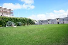 Partial view of Commissioner's House & Statue of Neptune at National Museum of Bermuda.jpg