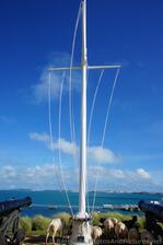Naval Flagpole with sheep grazing next to it at grounds of Bermuda Maritime Museum.jpg
